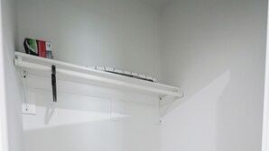 A small, empty room with white walls, a wooden floor, and a white ceiling with a light fixture. - 1Bed/1Bath_KingBed Central+W/D+WIFi (Philadelphia)