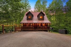 A cabin with a porch, two windows, and a mailbox. - Peaceful 2-Bedroom Cabin with Game Loft, Hot Tub & Fireplaces (Sevierville)