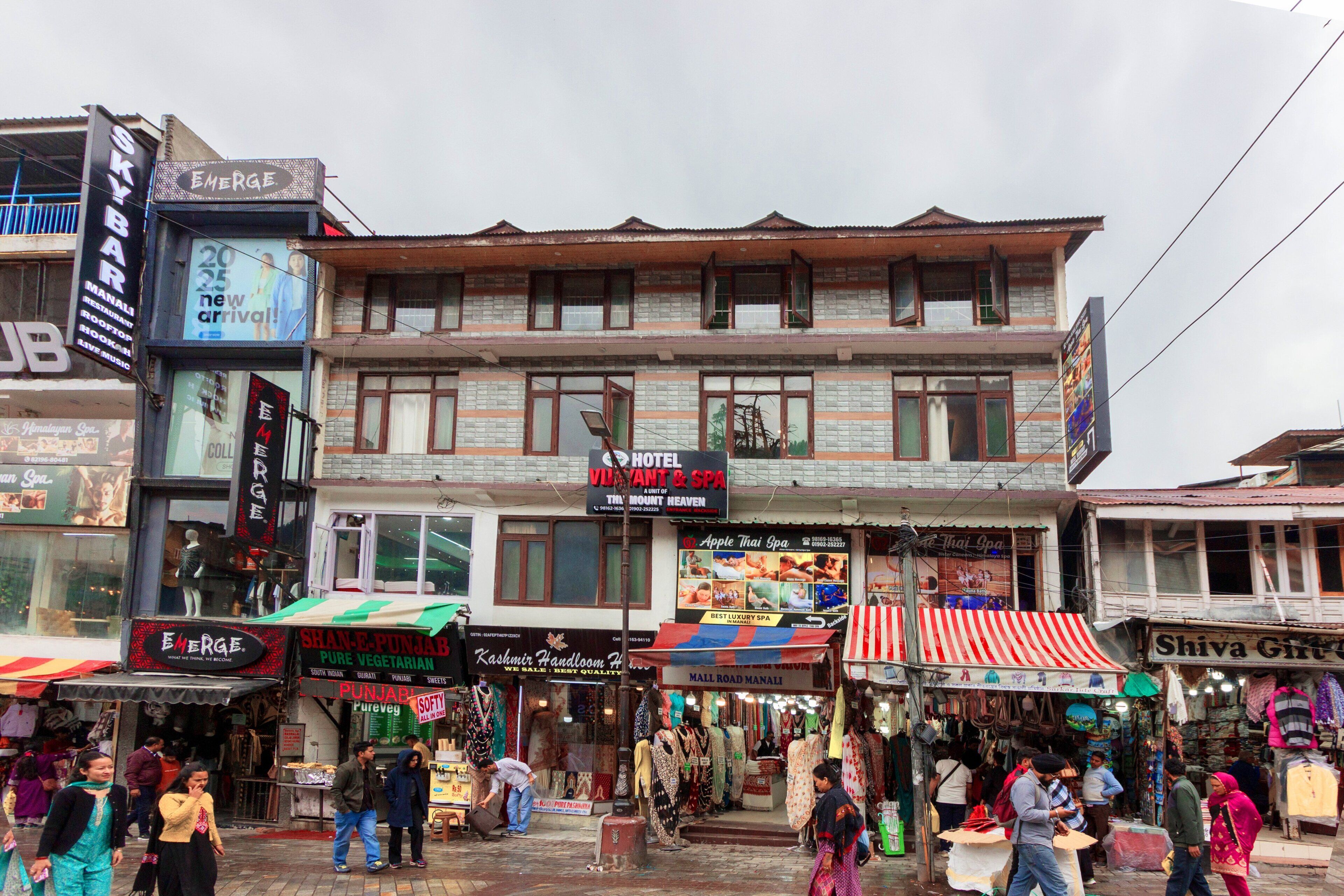 A hotel with a signboard advertising a spa and a restaurant.