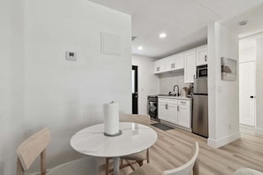 Enjoy meals in this well-equipped kitchen with a dining area for two.