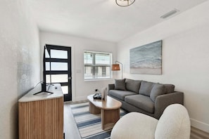 Relax in a stylish living room with a sofa, armchair, and coffee table.