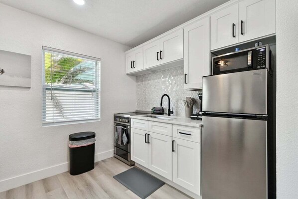 Enjoy cooking in this well-equipped kitchen with stainless steel appliances and ample counter space.
