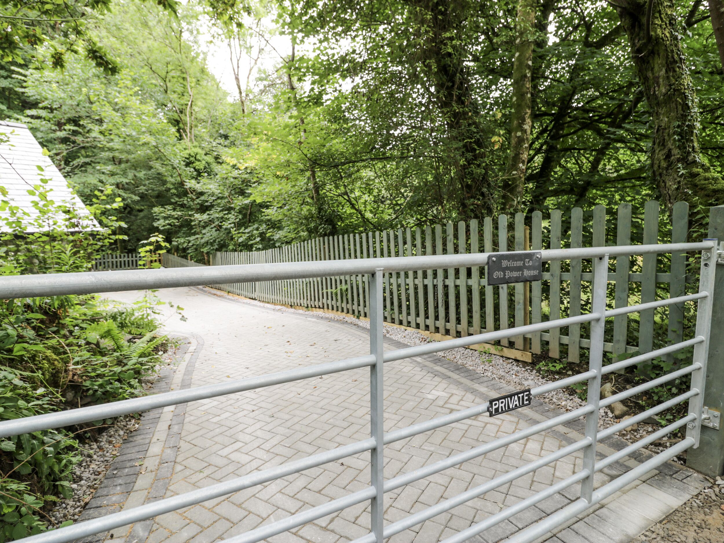 A gated entrance to a park with a sign reading "Welcome to Old Water House."