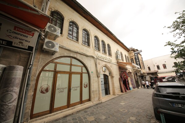 A building with a large arched window and a sign that reads "Arangah Çiftel." -  Arangah Konagı (Sanliurfa)