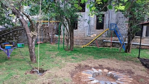 A playground with swings, a slide, and a climbing structure.