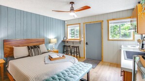 A bedroom with a bed, a bench, a desk, and a window. - Hike & Fish: Mountain Getaway in Avery! (Avery)