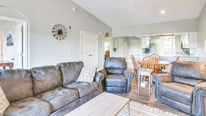 A living room with a sofa, two armchairs, a coffee table, and a dining area with a table and chairs. - 1 Mi to 76 Strip: Family Condo in Branson! (Branson)