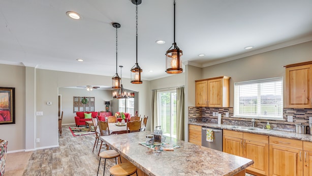 A spacious kitchen with a large island, wooden cabinets, and pendant lighting. - 10 Mi to Aztec Ruins: Family Home w/ Large Yard! (Aztec)
