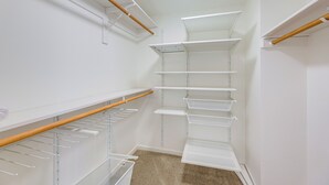 A corner closet with multiple white shelves and a wooden rod. - Pool & Trail Access On-site: Modern Austin Condo! (Austin)