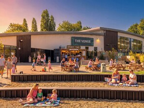A modern building with a sign reading "THE VENUE" and "SMASH'D TOWN" on the side.
