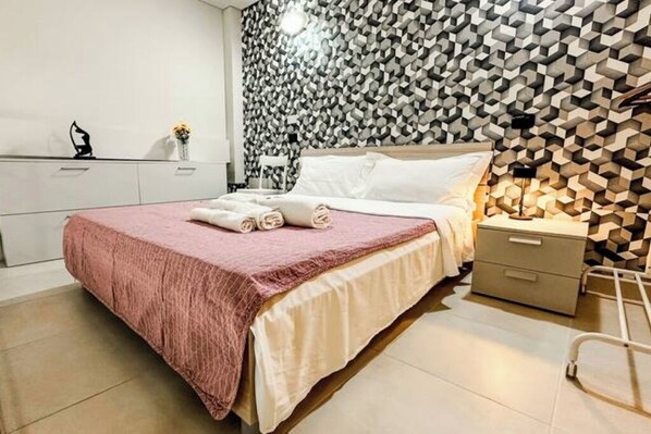 1 bedroom, desk, iron/ironing board, travel crib