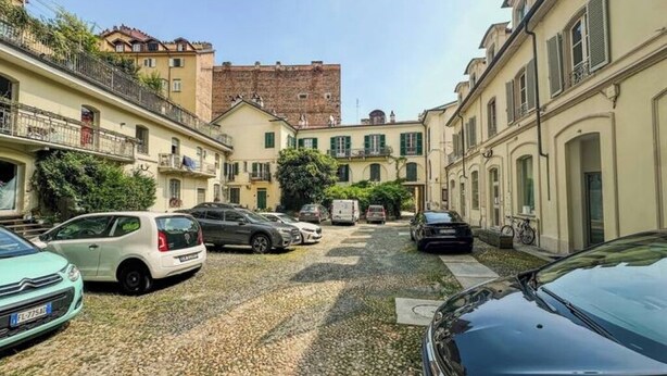 A street with parked cars and buildings.