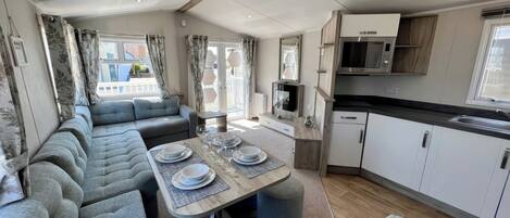 A compact living space with a dining area, kitchenette, and seating.