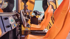 A racing simulator with orange seats and a steering wheel, featuring a SEGA logo. - Mariner's Meadow - Hayling Island (Hayling Island)