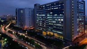 A multi-story building with numerous windows and a central courtyard. - Let Home (Hyderabad)