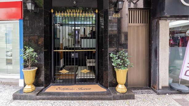 A hotel entrance with a black gate, a number 668, and two potted plants on either side. - 8 Minutes From Copacabana Beach Br1010 (Rio de Janeiro)