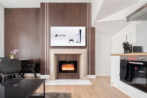 Superior Apartment | Living room | 65-inch Smart TV with digital channels, Netflix, Hulu