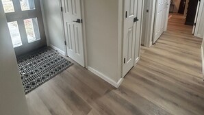 A hallway with wooden flooring, white walls, and three white doors. - 3-bedroom house in peaceful Independence. Enjoy your stay (Independence)