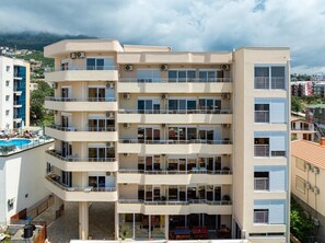 A multi-story building with balconies and a pool area. - Saray Hotel (Bar)