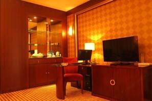 Cozy retreat with a wooden cabinet, flat-screen TV, and comfortable seating area.