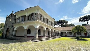 A large building with a central courtyard, featuring a series of arches and a prominent entrance.
