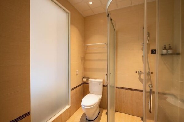 A compact bathroom with a toilet, a glass shower enclosure, and a towel rack. - L.V.BAY (Shenzhen)