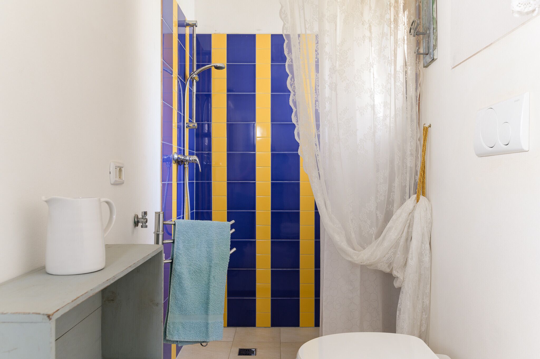 A bathroom with a shower, a sink, and a toilet.