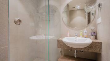 Shower, hair dryer, towels, toilet paper