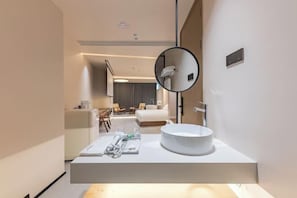 Enjoy a clean and uncluttered bathroom experience with a large sink, mirror, and towel rack.