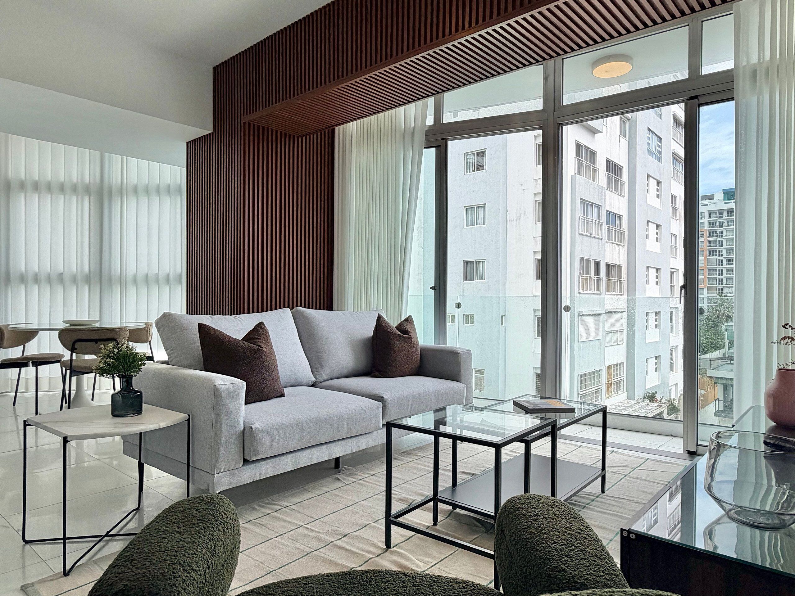 A modern living room with a sofa, coffee table, and chairs.