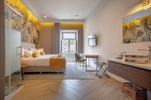 A modern hotel room with a bed, desk, and bathroom. - Guest House Jacarandá Faro (Faro)