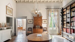 A room with a round wooden table, a chandelier, a wooden cabinet, and a bookshelf. - Stunning Venetian Villa, with pool, set in a private park in the Euganean Hills (Este)