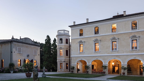 A large, historic building with multiple arched entrances and a tower. - Stunning Venetian Villa, with pool, set in a private park in the Euganean Hills (Este)