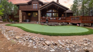 A large wooden house with a deck and a well-maintained lawn. - European Rustic Mountain Retreat in Torreon (Show Low)
