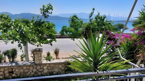 A balcony with a view of a lake, boats, and mountains. - Room 'Double  Mountain View 1' with Mountain View, Wi-Fi and Air Conditioning (Nikiana)
