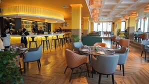 A modern restaurant with a bar area, wooden flooring, and contemporary seating. - Concorde Creek View Hotel (Dubai)