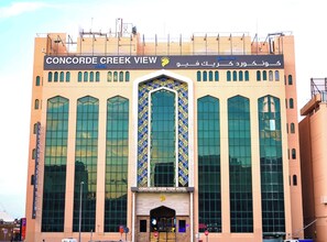 The exterior of the Concorde Creek View Hotel with large windows and a prominent entrance. - Concorde Creek View Hotel (Dubai)