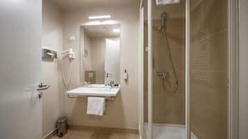 A bathroom with a sink, mirror, towel rack, and shower.