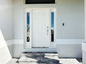 A white door with a keyhole and a doorbell. - 2 BR Canal-Front Paradise, Heated Pool, Beaches & Gulf Coast (Rotonda West)