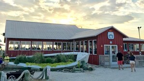 A red building with a sign indicating it is a restaurant. - 3-bedroom house in charming Cape Charles with pool access. (Cape Charles)