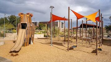 A playground with a slide and climbing structures.