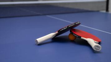 A table tennis table with a blue surface and a net.
