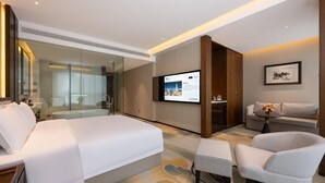 A modern hotel room with a large bed, a desk, a chair, and a television. - Grand Madison Hotel Jining Yongrun (Jining)