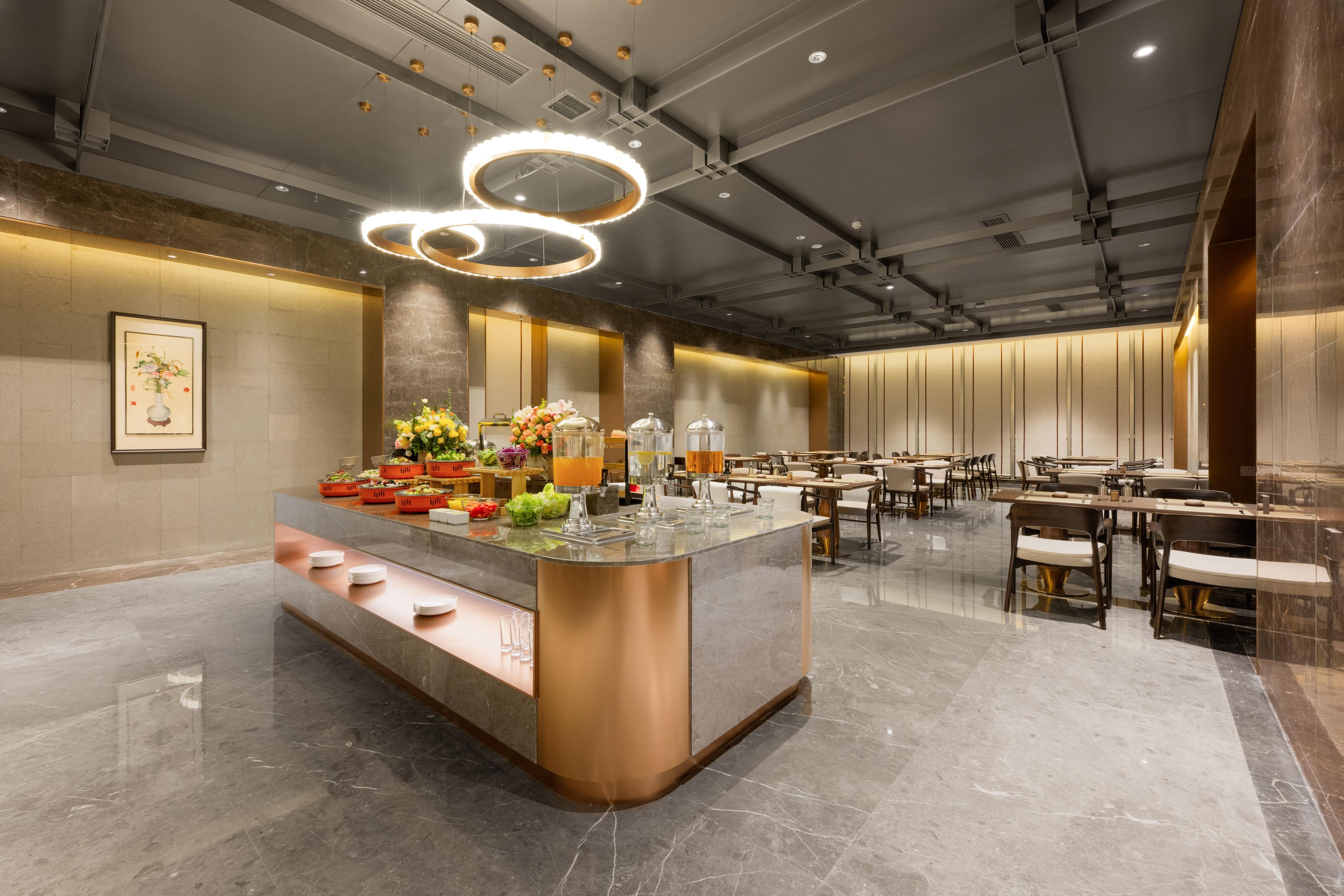 A modern hotel lobby with a central bar area, seating arrangements, and a polished marble floor.