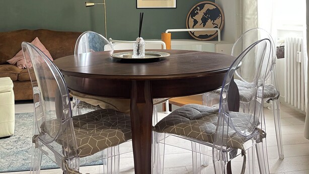 A dining area with a round table, clear chairs, a globe wall art piece, and a large mirror. - Tranquility and comfort near Careggi, 10 min from center by tramway (Firenze)
