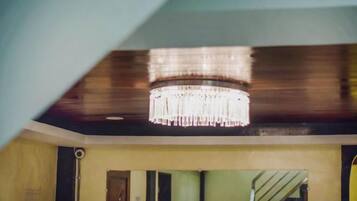 Ein Zimmer mit einer Chandelier, einer Treppe und einer Tür.