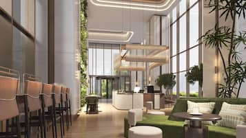 A modern lobby with a central staircase, seating areas, and large windows.