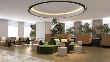 A modern lounge area with a circular ceiling light, seating arrangements, and potted plants.