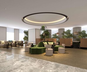 A modern lounge area with a circular ceiling light, seating arrangements, and potted plants. - Hilton Garden Inn Chongqing Yubei Central Park (Chongqing)