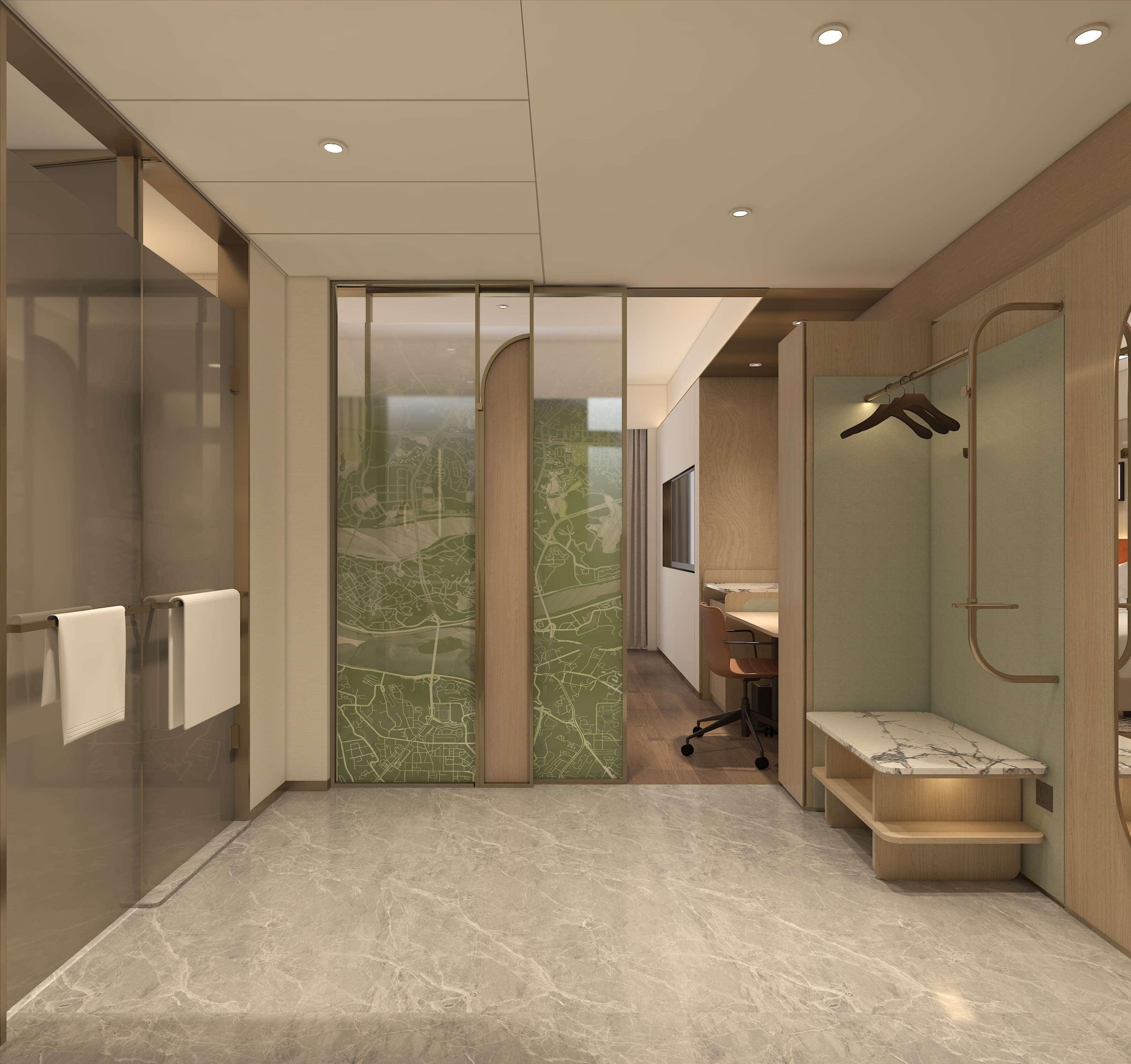 A modern bathroom with a shower, a vanity, and a seating area.